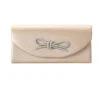 CLASSIC BOW CLUTCH BAG IN CHAMPAGNE